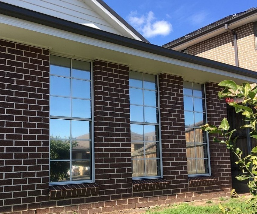 TMC Tinting residential window tinting Sydney — reflective solar control film installed on brick home windows