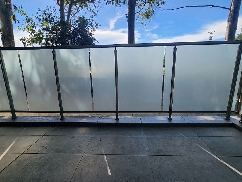 TMC Tinting glass frosting Sydney — frosted privacy film installed on outdoor balcony glass balustrade panels