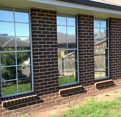 TMC Tinting residential window tinting Sydney — solar control film on double storey brick home