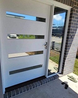 TMC Tinting residential window tinting Sydney — reflective mirror film installed on timber front entry door