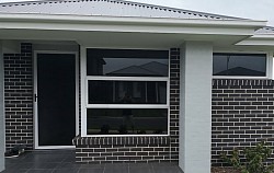 residential brick home: TMC Tinting residential window tinting Sydney reflective solar film installed