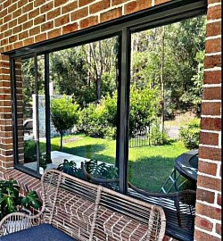 garden view through tinted window: TMC Tinting home window tinting Sydney solar film view from outside